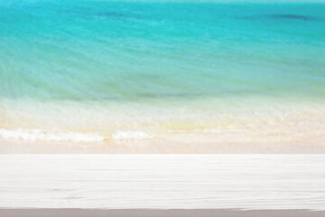 White wood table top on blur sea background