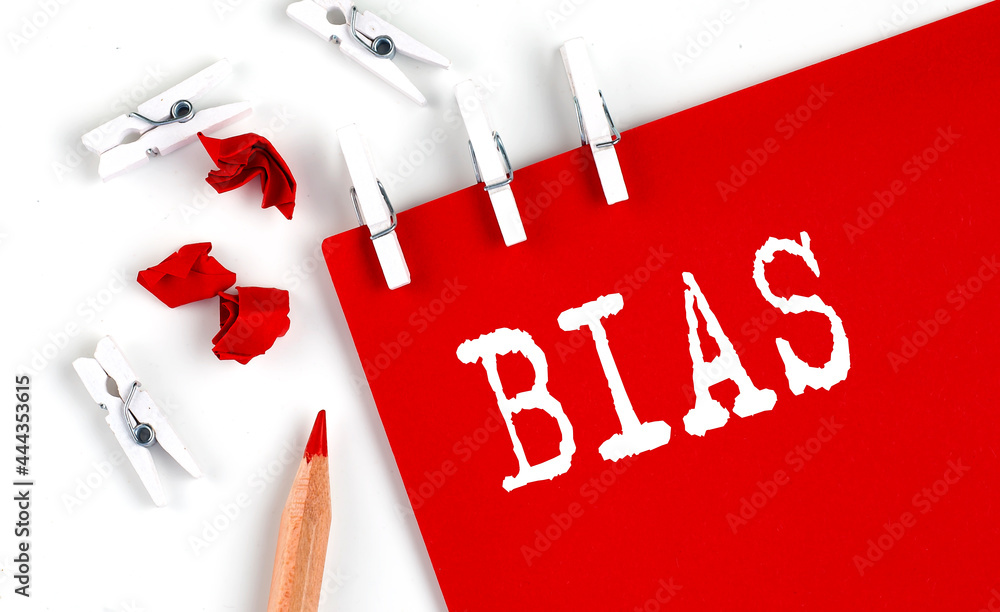 Poster bias text on red paper with office tools on white background