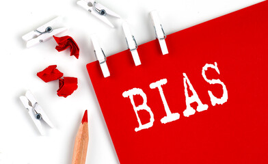 BIAS text on red paper with office tools on white background
