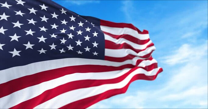 close up view of the american flag waving in the wind.