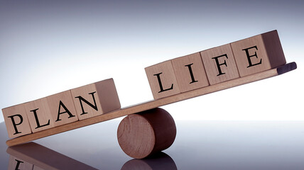 Wooden seesaw representing imbalance between PLAN and LIFE isolated over black background
