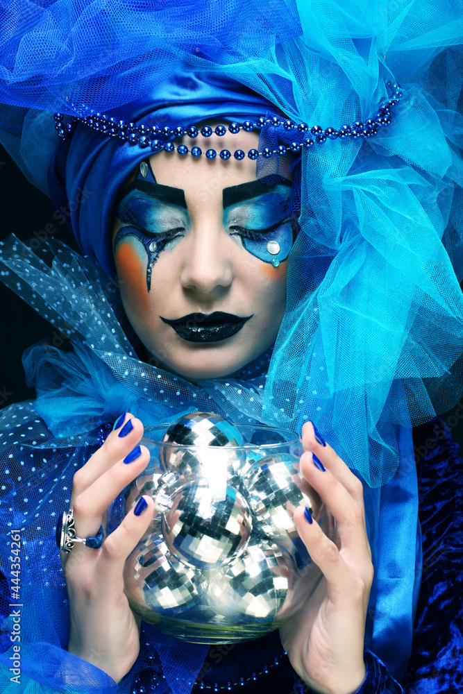 Poster Beautiful young woman with artistic make-up holding christmas balls.