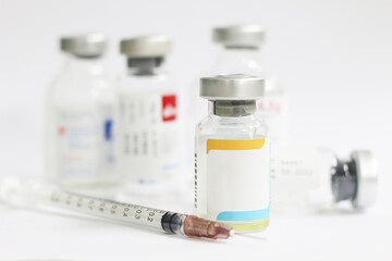 vaccine and syringe on white background with copy space for text