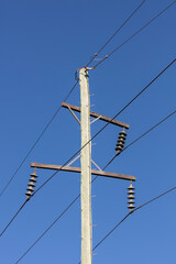 Obraz premium Photograph of a wooden telephone post and cables