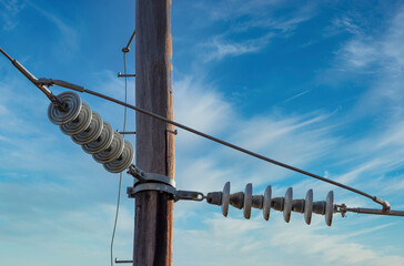 Photograph of a wooden telephone post and cables