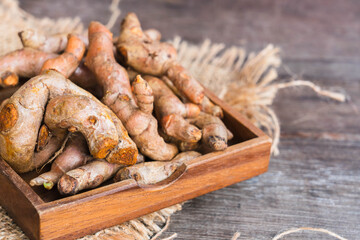 Turmeric in a wooden saucer.