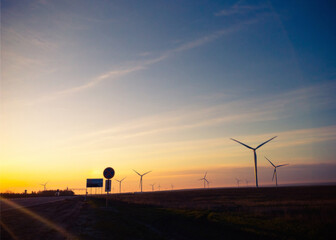 wind electric power plant at sunrise