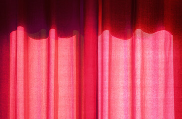 red curtain drapes portieres on sunny window