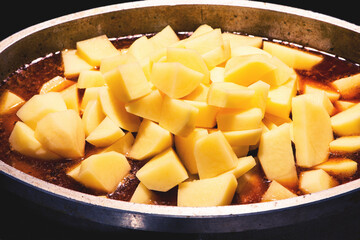 cooking the potato roast in tomato broth