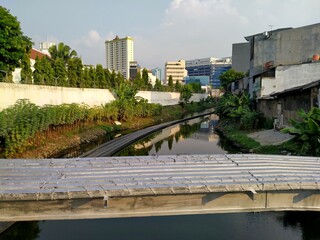 Kota tua, Jakarta, Indonesia - (06-10-2021) : Dirty black river atmosphere with high rise building background