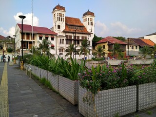 Kota tua, Jakarta, Indonesia - (06-10-2021) : Historical building with flower pots in the foreground in the old town tourist area