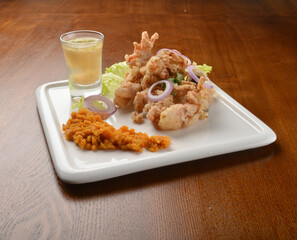 deep fried octopus seafood with lime juice appetiser on wood table fine dining western menu