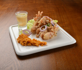 deep fried octopus seafood with lime juice appetiser on wood table fine dining western menu