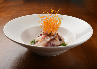 cold dish octopus sashimi salad with green vegetables and carrot appetiser on wood table fine dining western menu