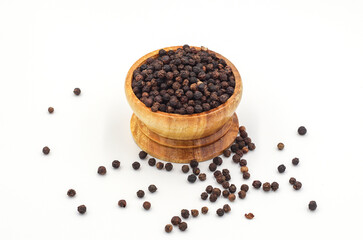 black pepper in a wooden bowl isolated on white background