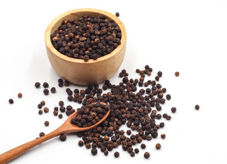 black pepper in a wooden bowl isolated on white background