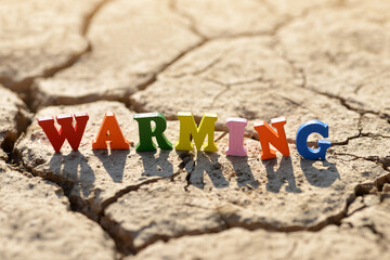 Text Warming on arid cracked soil. Concept of climate change.