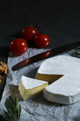 Still life with cheese on a dark background