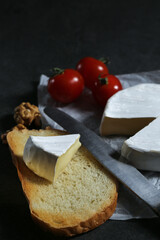 Still life with cheese on a dark background