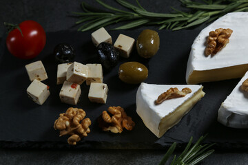 Still life with cheese on a dark background