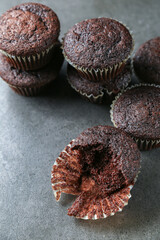 Delicious and fresh chocolate muffins on a gray ceramic table.