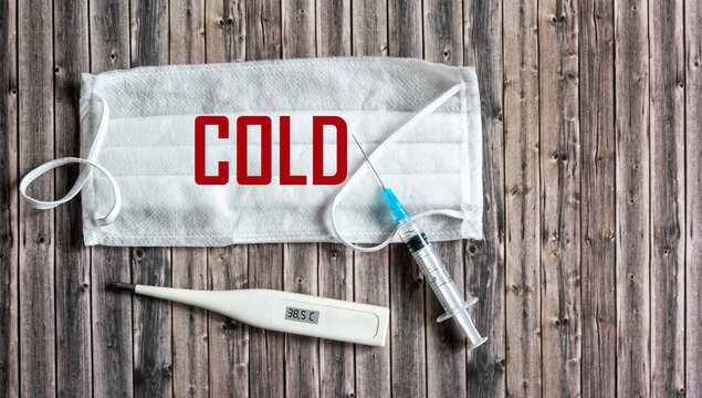 Cold season concept. The text is coldly written on a medical mask.