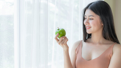 Beautiful beauty sexy woman slim holding green apple on white bedroom background