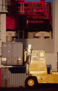 Forklift working with shipping containers at the port