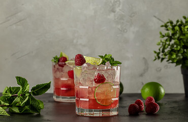 Raspberry Lime Vodka Cocktail with mint and ice. Refreshing alcoholic drink.