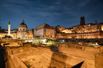Trojan column and churches of Santa Maria di Loreto. Ruins of a forum of Trajan in the night....