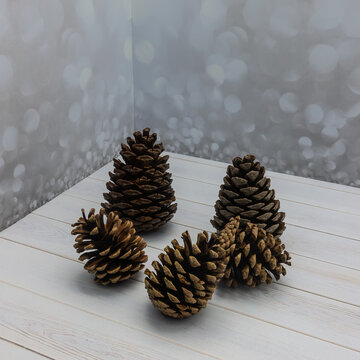 Dry pine cones on a white board table. The scales are open. Close-up