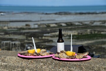two oyster plates with lemon by the sea with drink 
