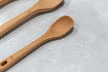 close up of wooden spoon on a marble kitchen bench room for text