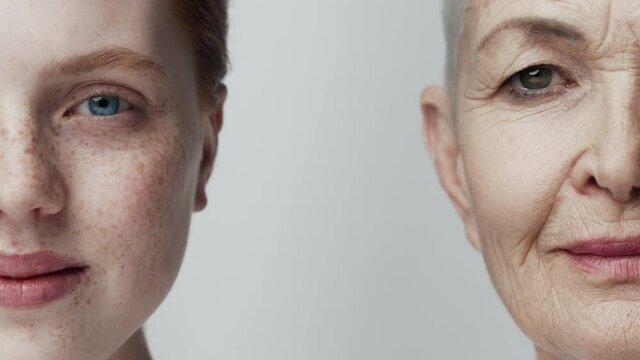 Two Woman Smiling Looking at Camera. Red Head Youth and Gray Mature Person View Close-up. People Emotion of Generation 20s and 60s years. Anti Age Wellness Health Concept. Smooth Pure Body Collagen 4k