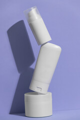 Set of blank white skincare cosmetic products on background with free space for advertising text. Floating empty moisturizer and hygiene bottle.