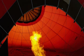 Deurstickers A burner blows hot air into a hot air balloon © Enrico Spetrino