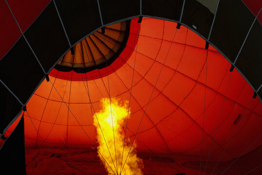 A burner blows hot air into a hot air balloon