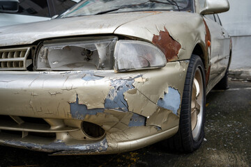 The side of the speculator has cracked headlights and peeling paint,old car that has never been...