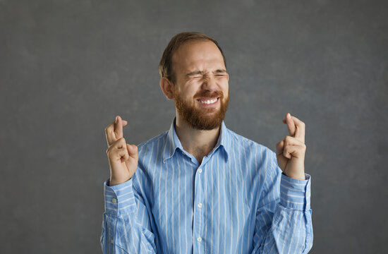 Please, Let Me Get This Job. Funny Young Business Man Or College Student In Office Shirt Asking God To Make His Wish Come True, Keeping Fingers Crossed, Believing In Luck And Hoping For The Best