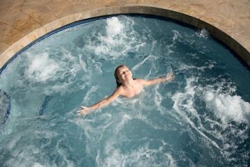 Kid in hot tub spa or swimming pool.