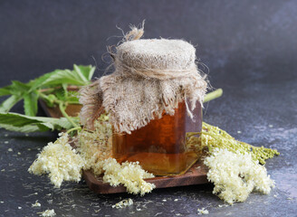 Medicinal tincture of meadowsweet in a glass jar.