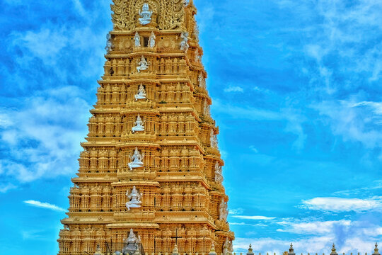 Chamundeshwari temple gopura with blue sky background.