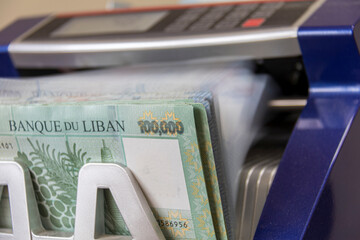 Lebanese Lira Currency being counted by a money counting machine
