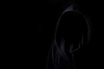 Faces are not visible in black robes in the dark on a black background