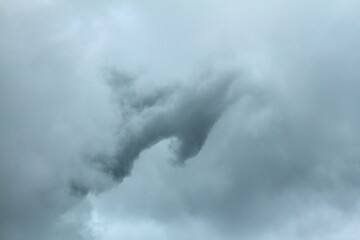 Dirty white clouds float in the sky.