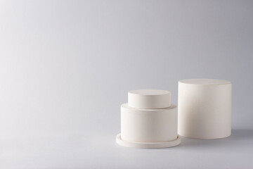 Composition with concrete cylinders in the style of minimalism on delicate background