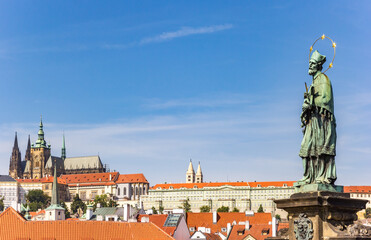 Statue on the Charles bridge overlooking the castle in Prague, Czech Republic