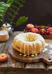 Buns with peaches and white chocolate. Fruits, coffee, wooden background, side view.