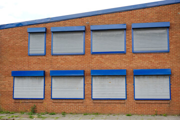 Office window shutters closed due to business closure