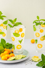 Cold refreshing drink with kumquats and mint, water with citrus fruits and ice